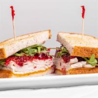 Turkey Cranberry Sandwich · Roasted turkey, cheddar cheese, arugula, house-made cranberry sauce on toasted gluten free m...