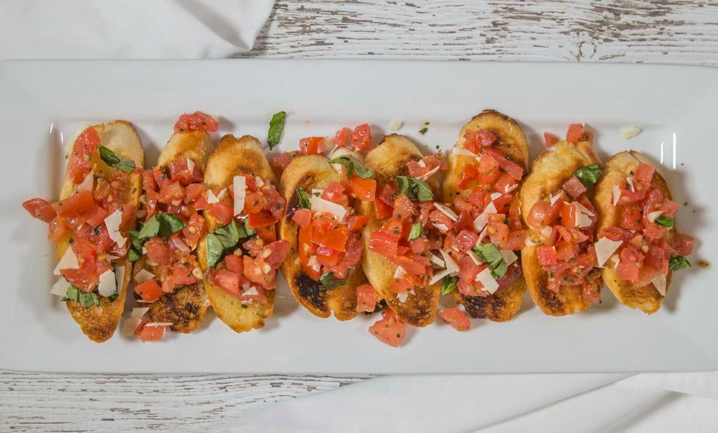 Lou'S Bruschetta · Roma tomatoes, fresh basil, olive oil and shaved parmesan on garlic rounds.