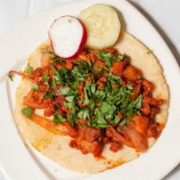 Taco Al Pastor · Marinated, spit roasted pork shoulder, grilled pineapple, onion & cilantro.