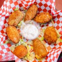 Chili Poppers · Creme cheese stuffed jalapeño peppers, dipped in spicy breading and fried.