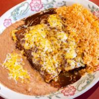 Enchiladas De Mole · Two corn tortillas stuffed with your choice of meat. Served with mole sauce.