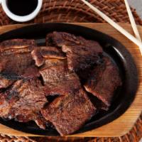 Kal Bi · Barbecued beef short ribs marinated in a  special sauce