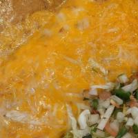 Breakfast Burrito* · Wheat or flour tortilla ~ 2 scrambled eggs ~ hash browns ~ smothered in pork green chili ~ m...
