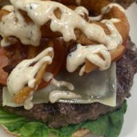 Cowboy Burger · 1/3 pound Angus Beef patty topped with Swiss cheese, crispy bacon, onion rings, and Alabama ...