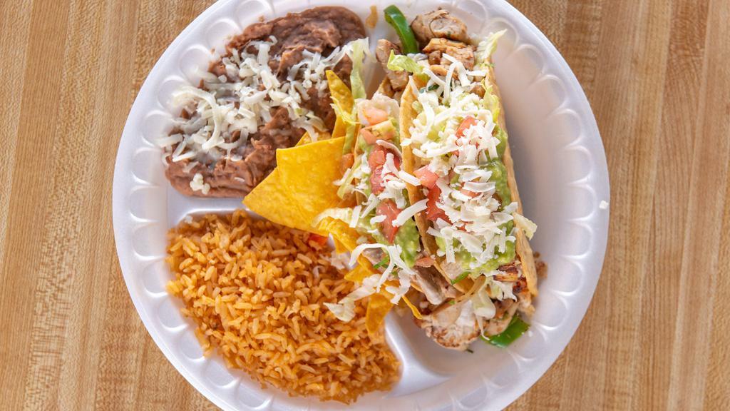 2 Tacos Hard Shell Combo · Two hard shell with choice of meat topped with lettuce tomatoes cheese guacamole onions and hot sauce with a side of rice and beans.