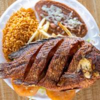 Mojarra Frita · Fried whole fish, served with fries and side rice beans and corn or flour tortillas.