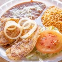 Fillet De Pescado Tilapia · Pan-seared tilapia with side of onions served with rice beans and order or corn or flour tor...