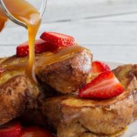 Chunky Cinnamon French Toast · 2 pieces of our chunky cinnamon french toast served with strawberries, whip cream, and homem...