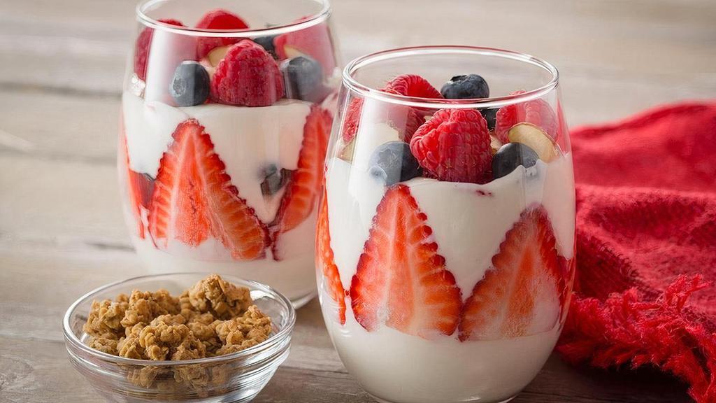 Vanilla Greek Parfait · Creamy vanilla Greek yogurt with fresh strawberries,raspberries and blueberries. Topped with a pinch of slivered almonds and served with a side of granola.