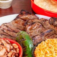 Plates Carne Asada · The steak Comes with rice, beans, a side of grilled onion and jalapeños tortillas.