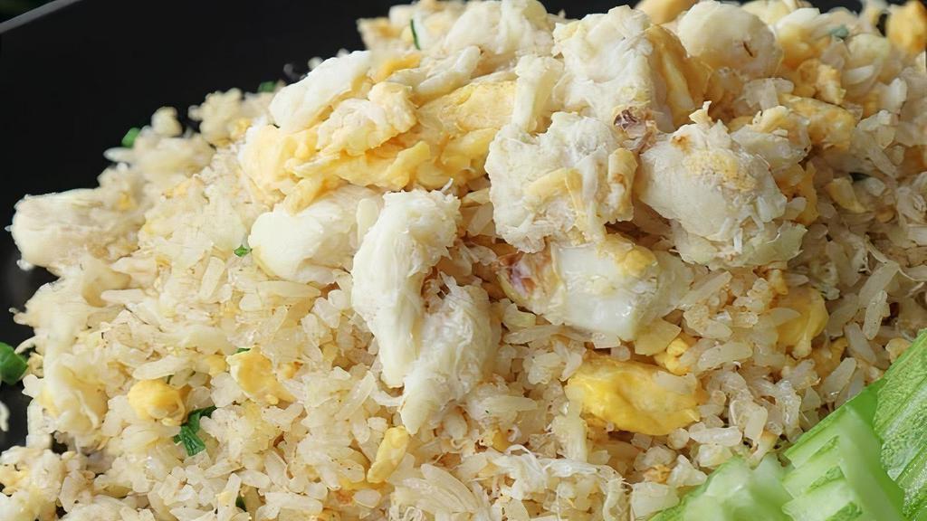 Crab Fried Rice · Fried rice with crab meat, egg, garlic, onion, tomato, black pepper, cilantro, scallion and side with cucumbers.