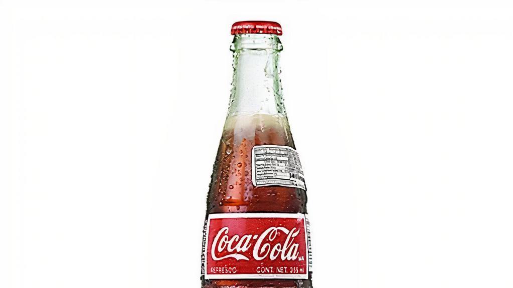 Coke · 12oz glass bottle of refreshing coca-cola. imported from Mexico with real cane sugar.