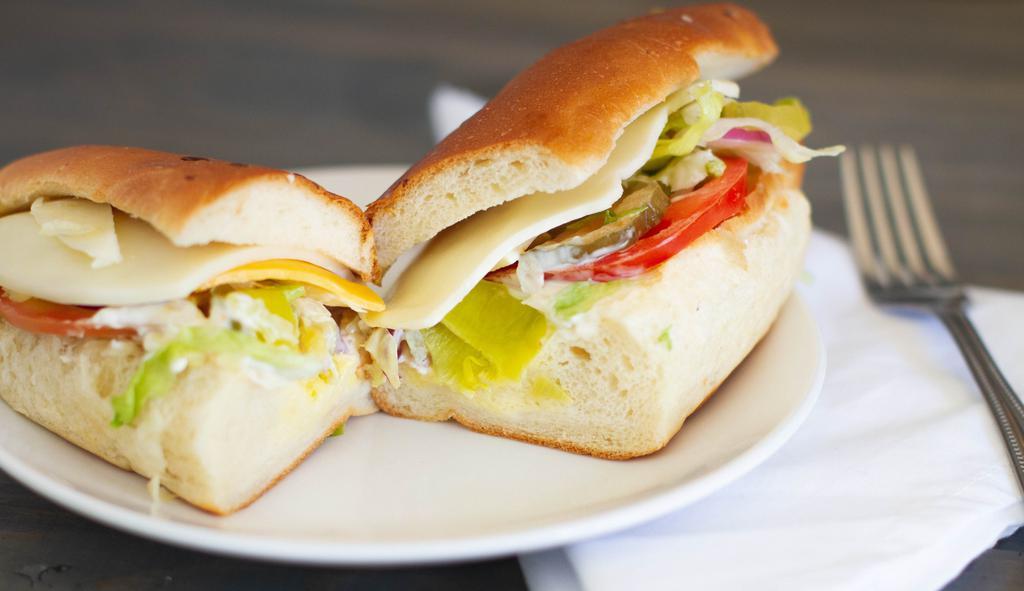 Veggie · Cheddar, Swiss & provolone cheese, lettuce, tomato, pickles, pepperoncini, Italian dressing & mayonnaise.