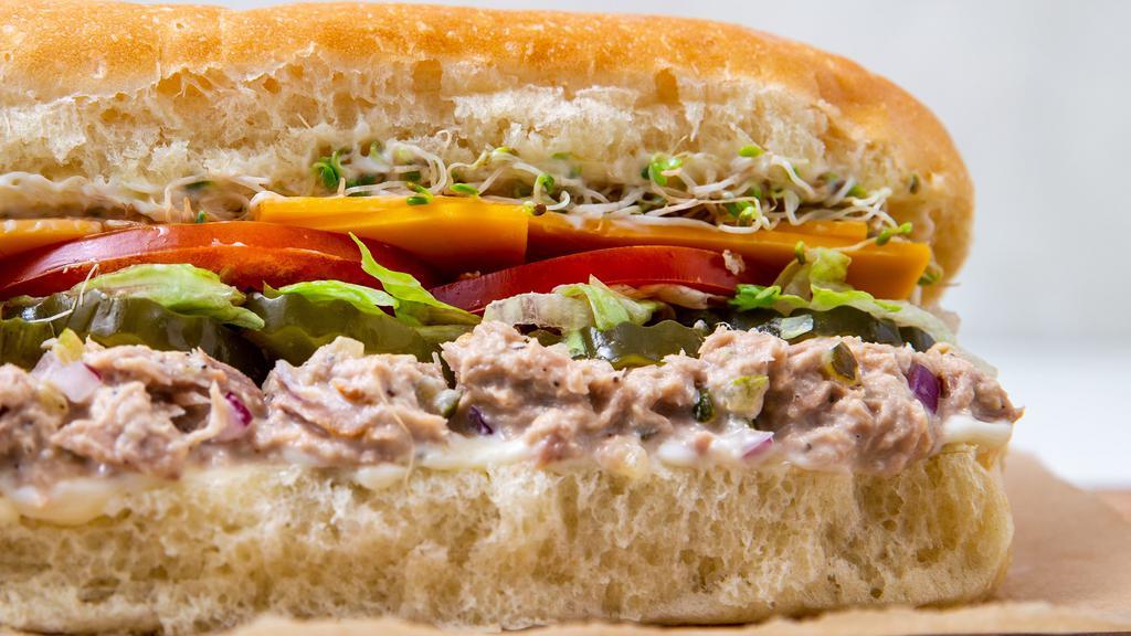 Tuna · Tuna mixed with diced onion, relish & mayo, cheddar cheese, lettuce, tomato, pickles & mayonnaise.