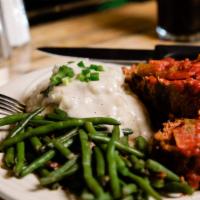 Mom’S Meat Loaf · Premium Angus ground beef blended with fresh ingredients, Topped with Zesty Tomato Sauce or ...