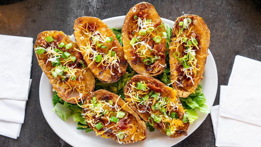 Potato Skins · Crispy potato skins loaded with melted cheese, crispy bacon and fresh chopped green onions. Served with your choice of dipping sauce.