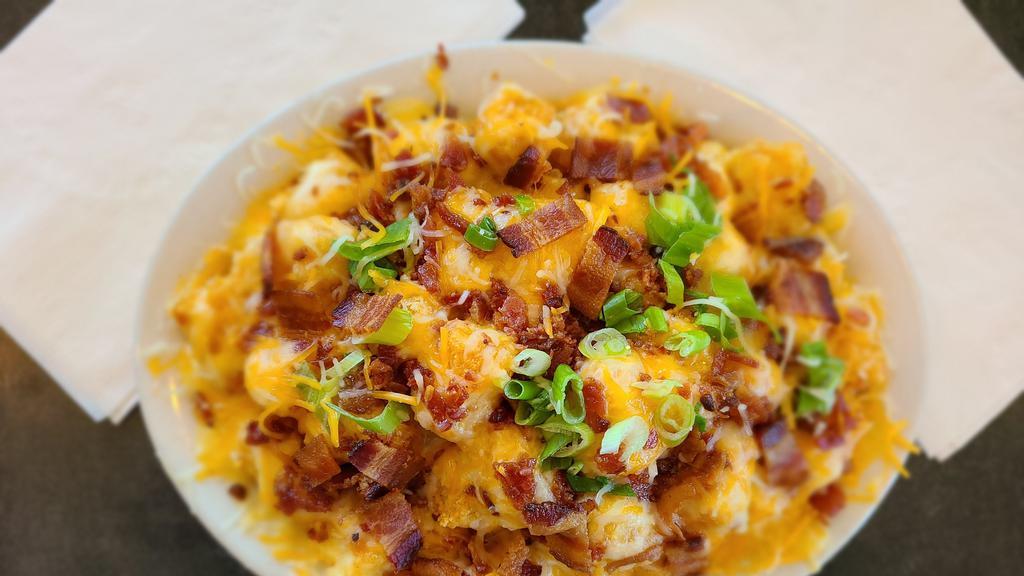 Loaded Tater Tots · Crispy tater tots loaded with melted cheese, crispy bacon and fresh chopped green onions. Served with your choice of dipping sauce.