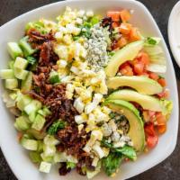 Classic Cobb Salad · Fresh mixed greens, chopped bacon, hard-boiled eggs, tomatoes, avocado, cucumbers and bleu c...