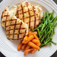 Grilled Chicken Breasts · Two plump charbroiled chicken breasts served on a bed of rice.