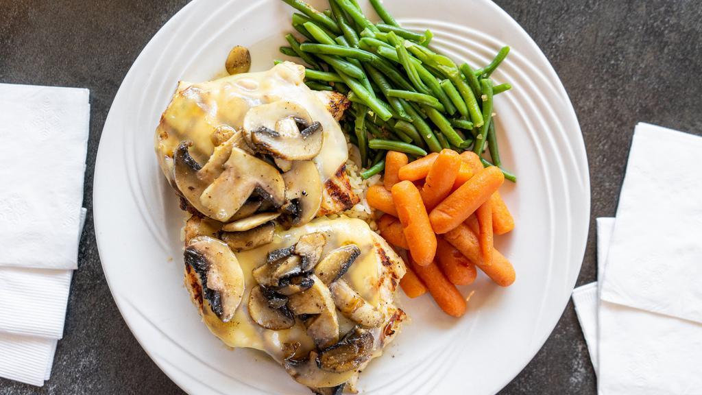 Mushroom Swiss Chicken · Two grilled chicken breasts topped with melted Swiss cheese and sauteed mushrooms, served on a bed of rice.