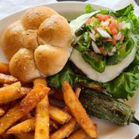 Caliente Burger · Cooked Medium Well and served with tomato, lettuce, pickles on a whole wheat bun with your c...