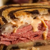Reuben Sandwich · Sliced corned beef sauerkraut swiss cheese and thousand island dressing on toasted marbled r...