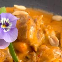 Massaman Lamb Curry · Stewed lamb in Thai massaman curry with peanuts, onions, potatoes, and Thai herbs.