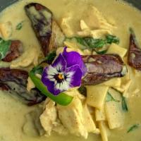 Green Curry · Spicy Thai herbs mixed with green curry in coconut milk, bamboo shoots, and eggplants.