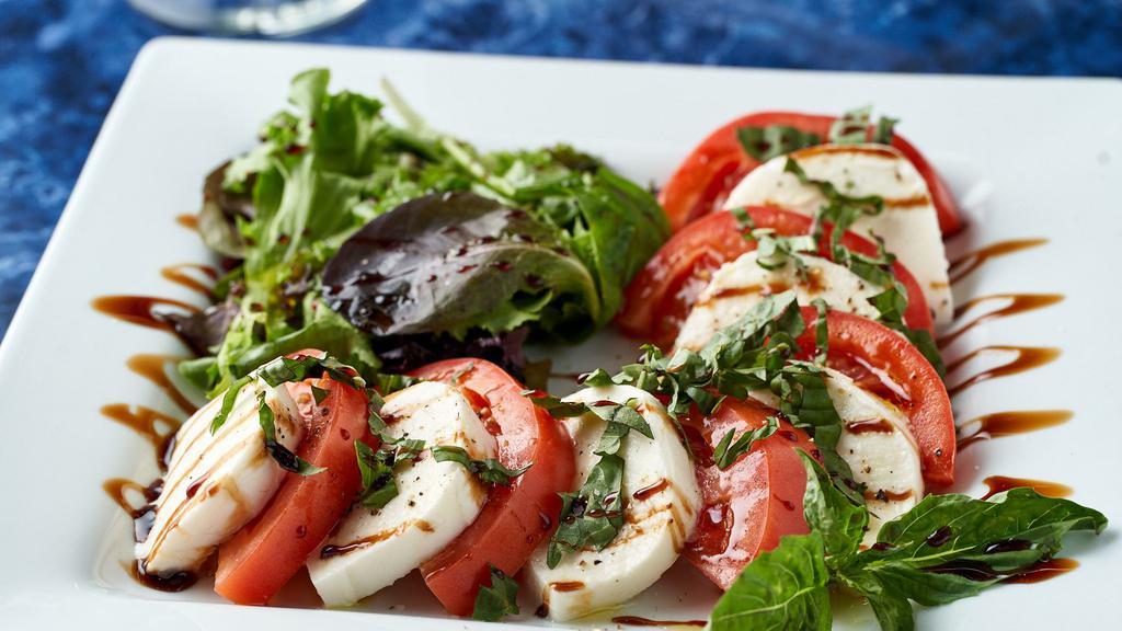 Caprese · Fresh mozzarella cheese, basil, tomatoes, mixed greens, olive oil and balsamic reduction.