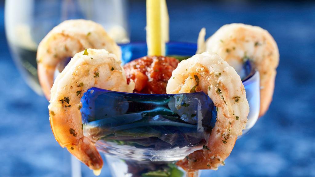 Tiger Shrimp Martini · Jumbo shrimp sautéed in brandy and herbs, served chilled with a chipotle cocktail sauce.