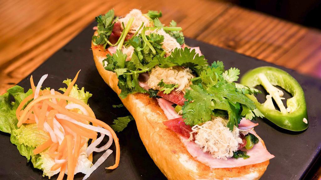 Spicy / Crispy Bánh Mì · Spicy. French bread with spicy sauce, sweet pork sausage, ham and topped with rousong.