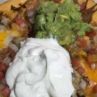 Super Nachos · Chips, beans, choice of chicken, ground beef, chorizo, or shredded beef. Topped with cheddar...