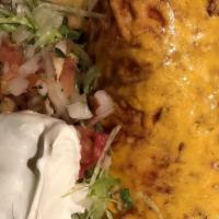 Carne Asada Burrito · A flour tortilla filled with skirt steak, rice, and beans topped with our own special red sa...