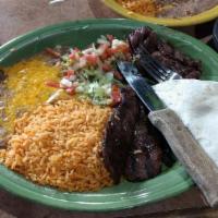 Carne Asada · Specialty marinated steak cooked to perfection. Served with Spanish rice and refried beans. ...