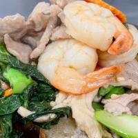 Rad Nah Poo Kao Fai · Wide rice noodles served with shrimp, chicken & pork  combination, egg, Chinese broccoli, ca...