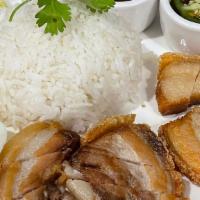 Khao Moo Graub Cha Chu · Crispy Pork Belly served with white rice, cucumber,  cilantro, house sauce and boiled egg.