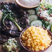 Carne Asada · Charbroiled skirt steak in special way served with rice, beans Salad, green onions & a fried...