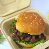 Teriyaki Beef Sandwich · Thin sliced, grilled Teriyaki Beef topped with green onions and served on a toasted sesame s...