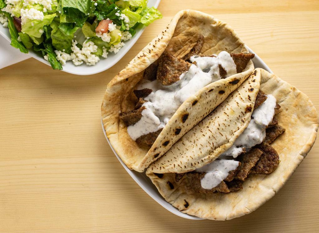 Gyro Boy · Gyro meat over rice, topped with tzatziki & served with a side of greek salad & Arabic pita.