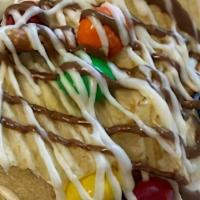 Snack Explosion · Soft baked sugar cookie dough smeared with vanilla frosting topped with pretzels, potato chi...