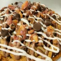 The Oink · Bacon Topped Chocolate Chip Cookie Stuffed with Creamy Cheesecake Filling Drizzled with Choc...