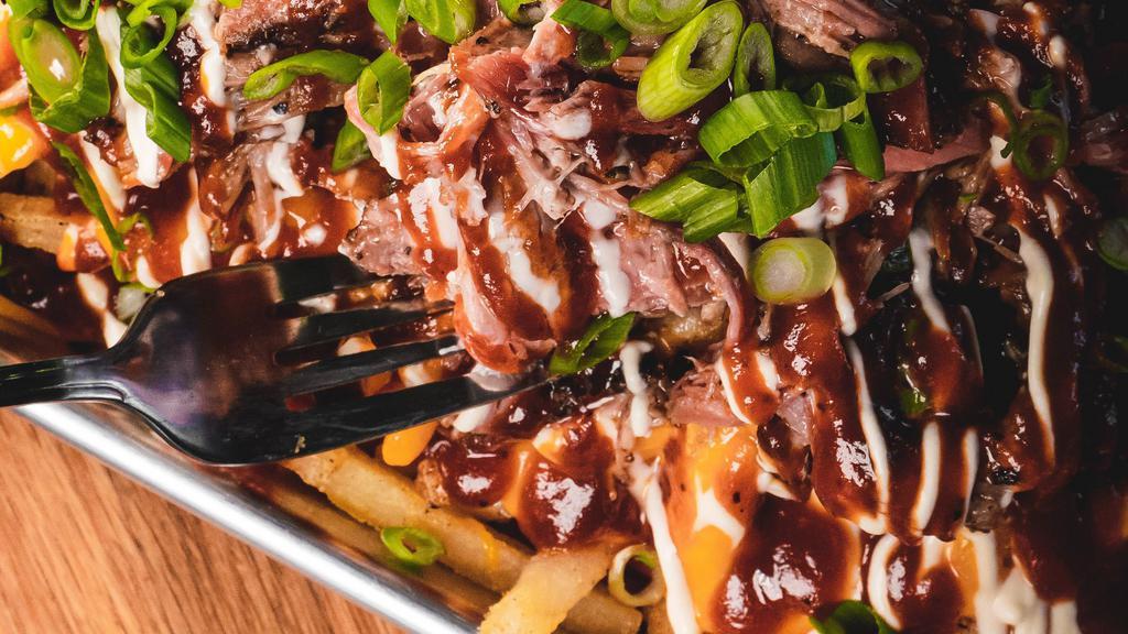 Carnitas Bbq Style Fries · Fries topped with BBQ sauce, cheddar, green onion, and sour cream.