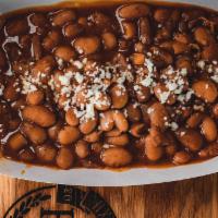 Beans · The style of beans we grew up with. Pintos with chipotle. We add a rich pork broth making th...