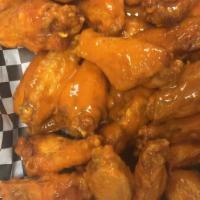 25 Bone In Wings · 25 Bone in wings TOSSED IN choice of up to 2 sauces ONLY and choice of blue cheese or ranch