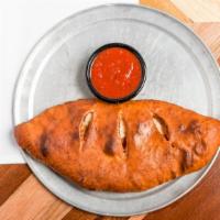 Calzone · Our Calzone is prepared with Walter’s Housemade Marinara and Freshly Grated Mozzeralla Chees...