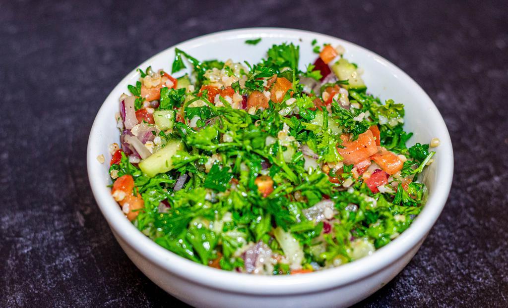 Tabouli Salad (Different)  · Bulgur (crushed wheat) mixed with parsley, onions, fresh tomatoes, cucumbers, and dressed with freshly squeezed lemon juice and olive oil.