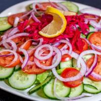 House Salad · Fresh lettuce mixed with fresh carrots, tomatoes, cucumbers, and topped with a citrus dressi...
