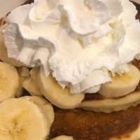 Banana Cakes · Our buttermilk pancakes cooked to perfection with banana slices inside and topped with more ...