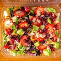 Sunnyside Strawberry Fields · Bed of power greens topped with cosmic crisp apples, strawberries, red grapes, avocado, drie...