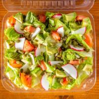 The Confident Caesar · Bed of romaine lettuce topped with  radishes, avocado, pumpkin seeds, and roma tomatoes.